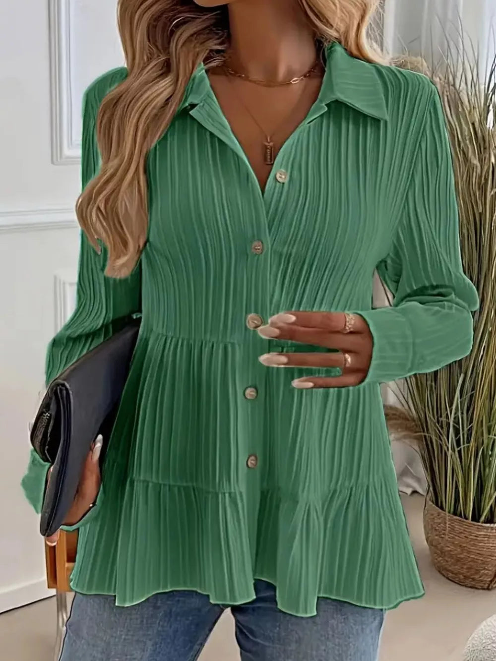 Green crinkled button-down shirt with tiered hem and long sleeves.