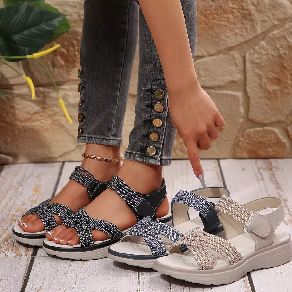Woven criss-cross platform sandals in blue, black, and khaki with adjustable straps.