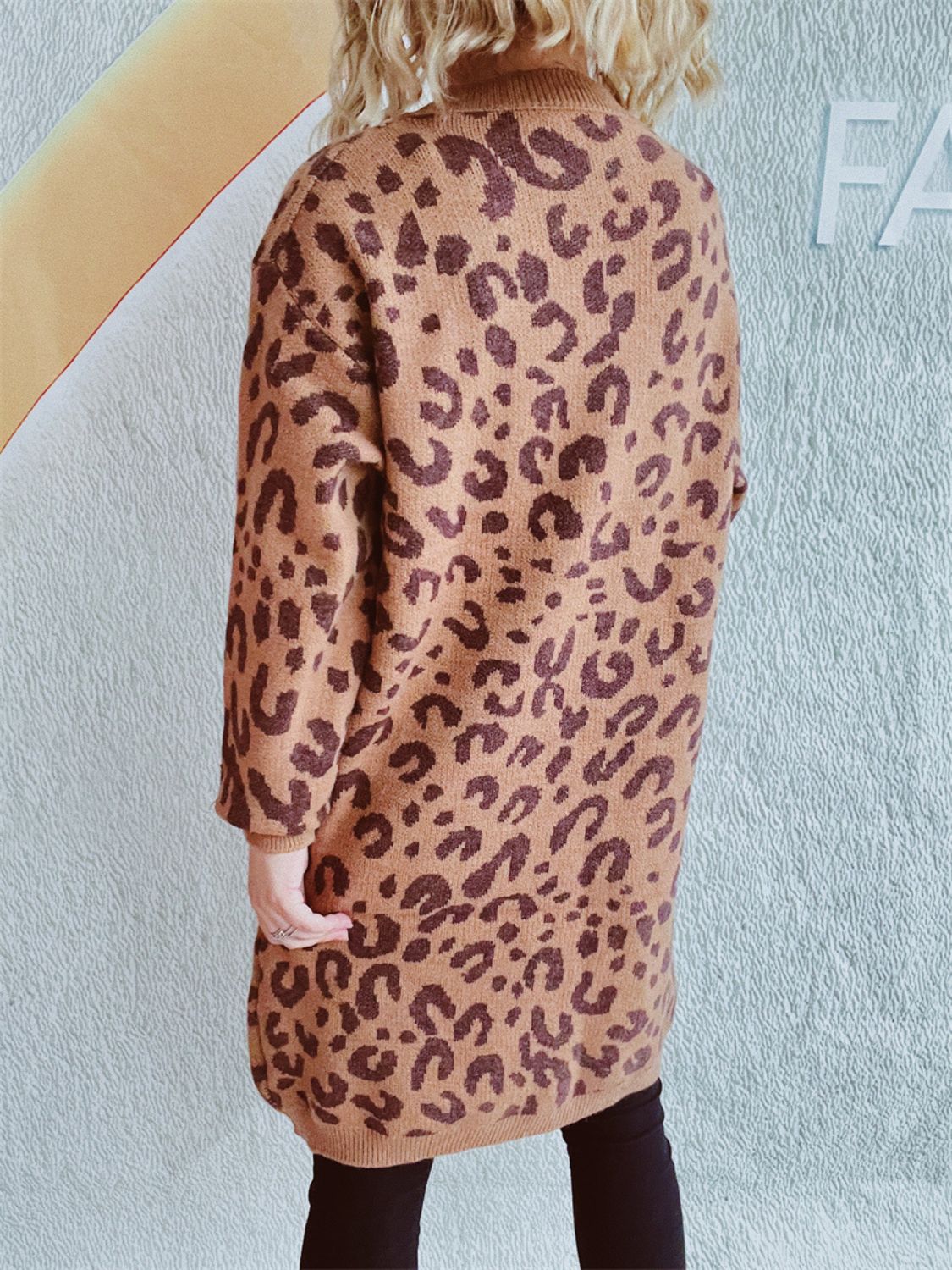 Caramel leopard print knit mini dress with a mock neck and long sleeves.