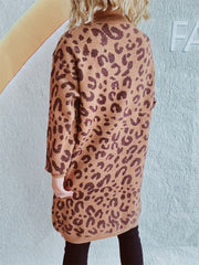 Caramel leopard print knit mini dress with a mock neck and long sleeves.