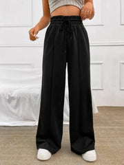 Black relaxed wide-leg sweatpants with drawstring waist and front seams.