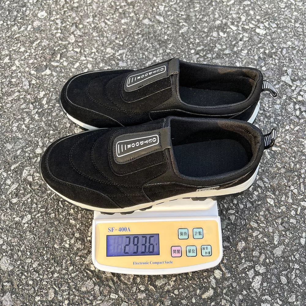 Black suede-like round toe slip-on sneakers with "OUTDOOR" detail.