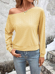 Yellow off-shoulder eyelet knit blouse with long sleeves and a relaxed fit.