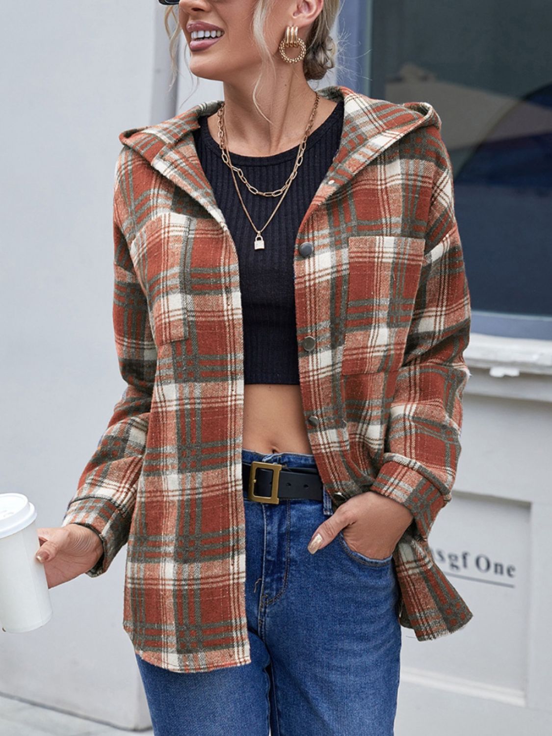 Plaid hooded shacket in brown with button front and chest pocket.