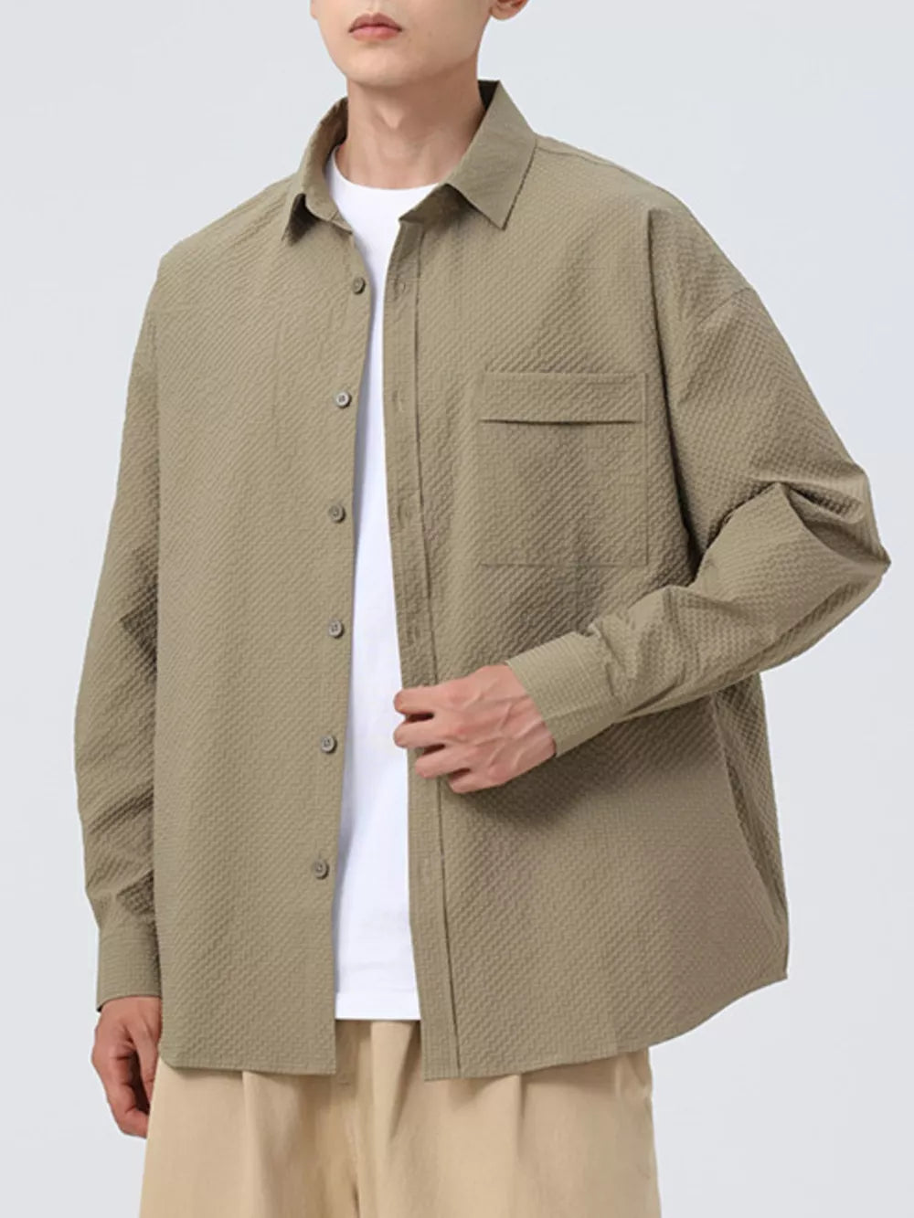 Textured oversized button-up shirt in pea green with a chest pocket and classic collar.