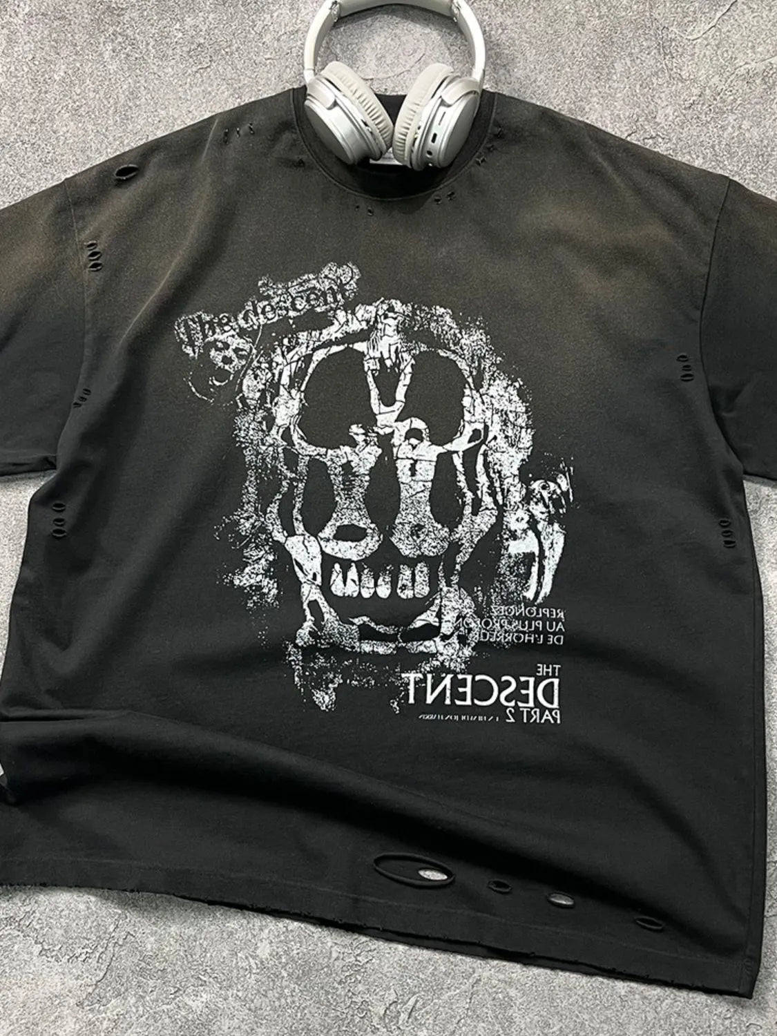 Black distressed graphic tee with skull and text print, crew neck, short sleeves.