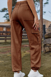 Brown cargo pants with elastic cuffs and multiple pockets.