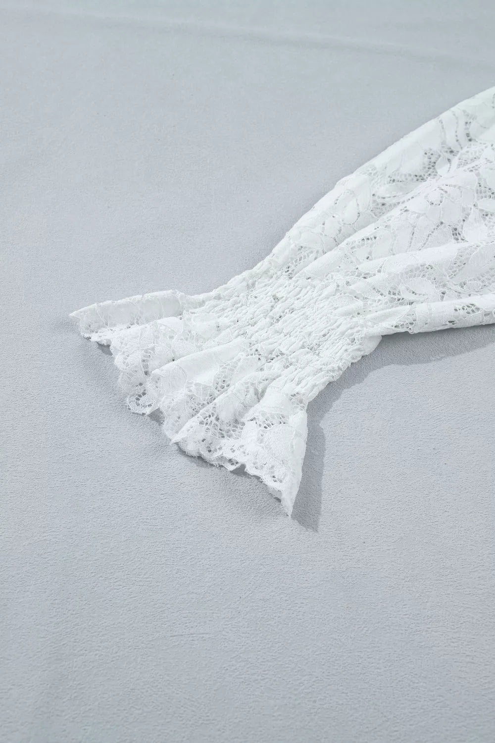 White lace blouse with smocked sleeve and ruffled cuff detail