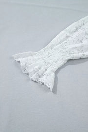 White lace blouse with smocked sleeve and ruffled cuff detail