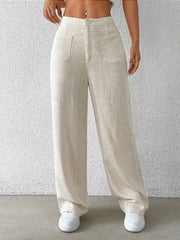 Cream linen wide-leg pants with button fly and dual patch pockets.
