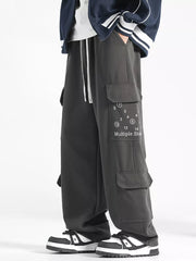 Gray cargo pants with drawstring waist and graphic detail on pocket