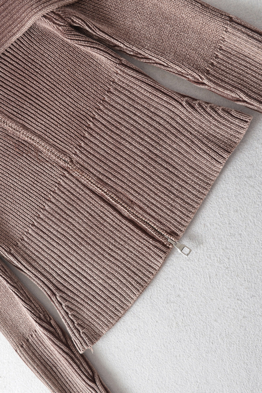 Ribbed taupe off-shoulder top with flare sleeves and a zipper detail.