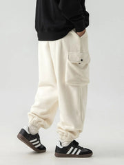 Ivory fleece cargo jogger trousers with elastic cuffs and a single button-flap pocket.