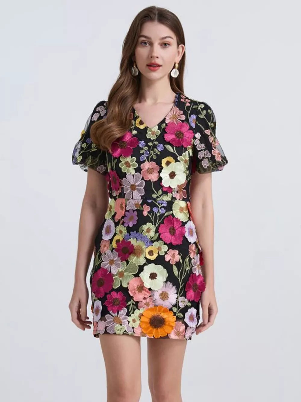 Embroidered floral mini dress in black with puff sleeves and V-neck.