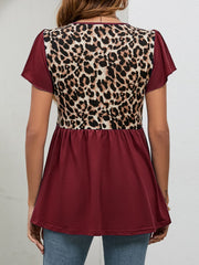 Burgundy peplum blouse with leopard print back panel and short flutter sleeves.