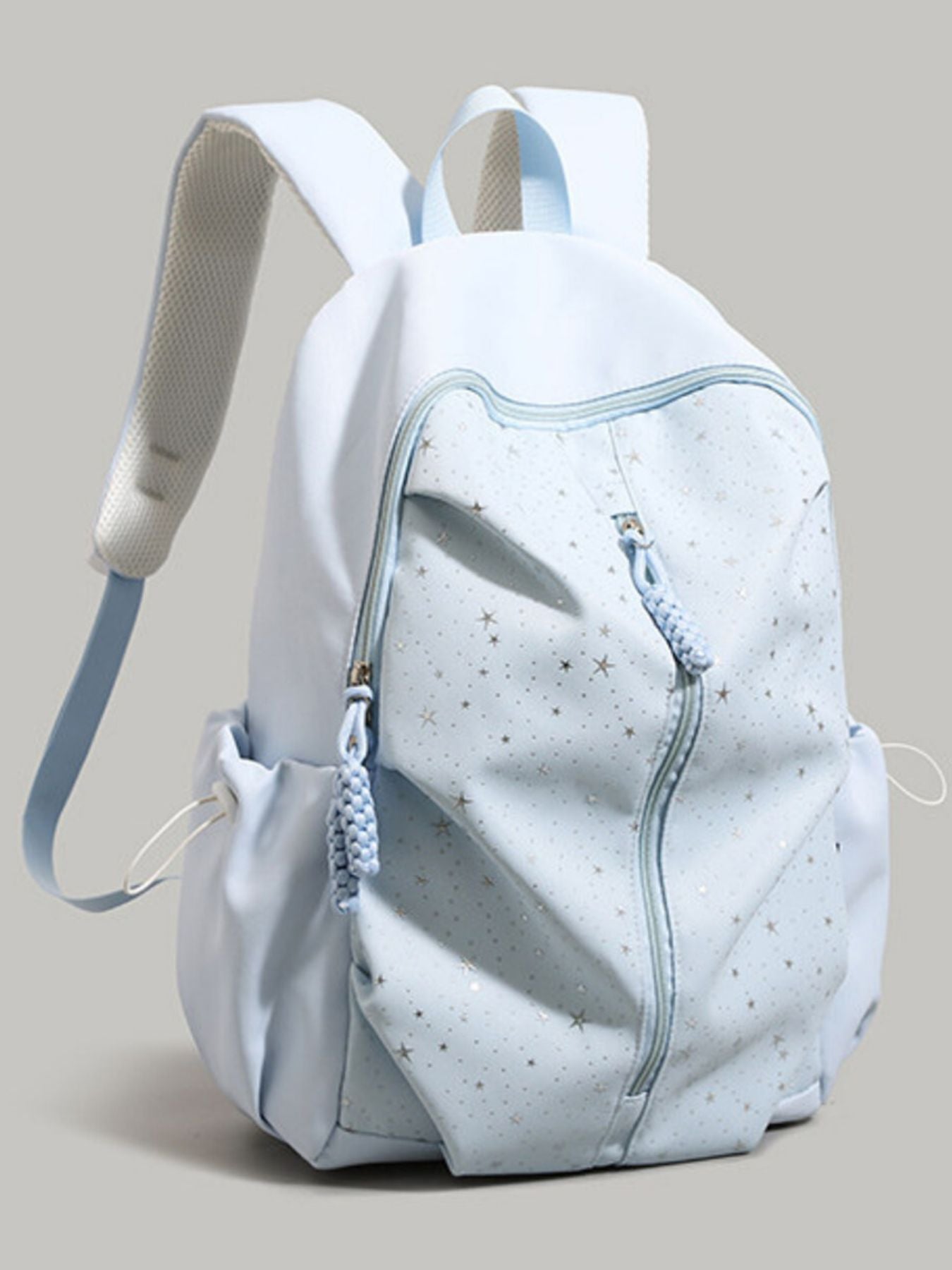 Blue nylon school backpack with scattered stars pattern and braided zipper pulls.