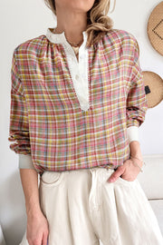 Bohemian plaid blouse with mandarin collar and buttoned placket in dusty pink hues.