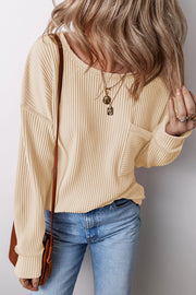 Tan ribbed knit long sleeve top with a patch pocket and crew neck.