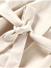 Beige belted trench coat with a tied waist detail