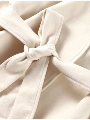 Beige belted trench coat with a tied waist detail