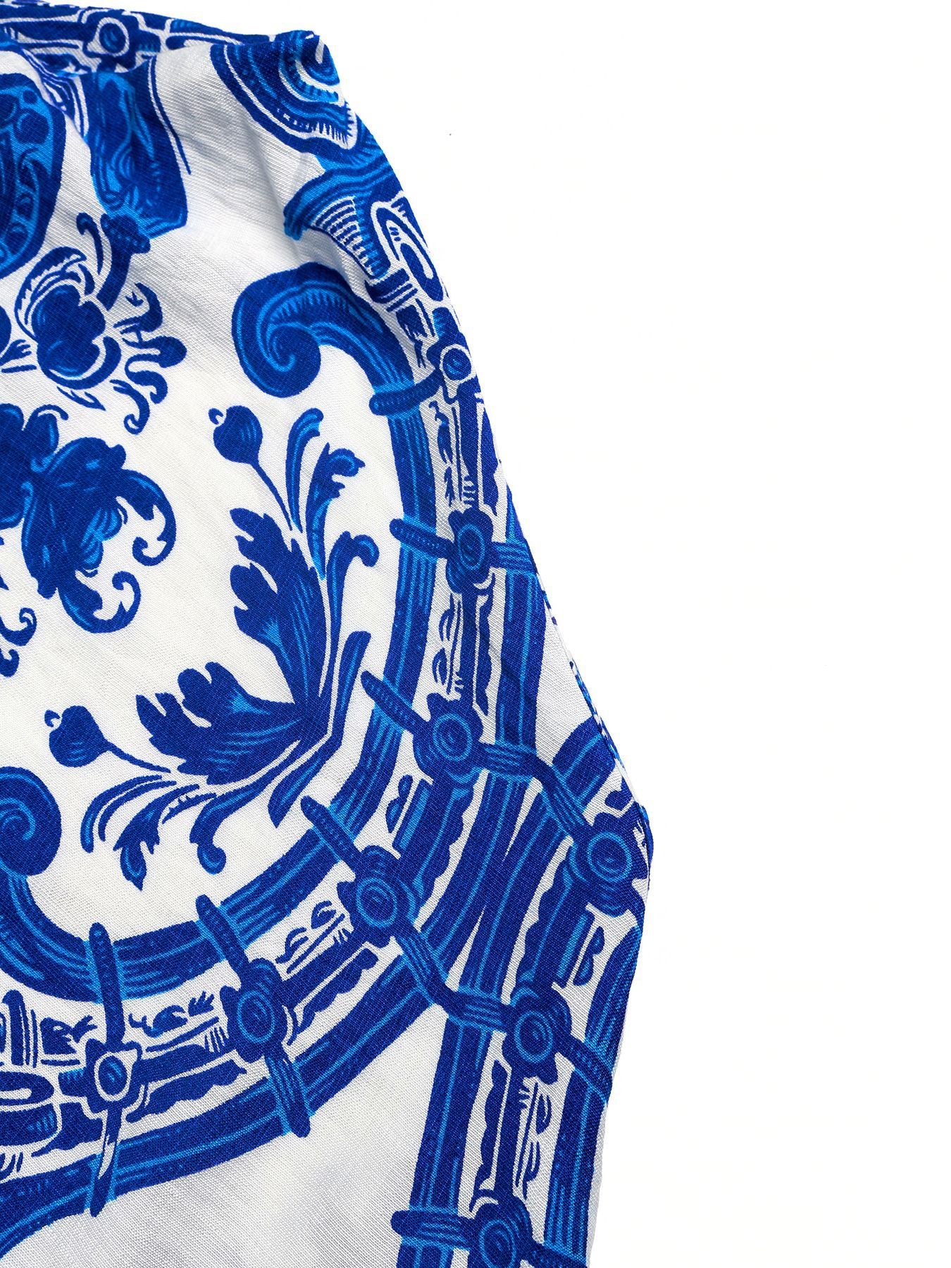 Crisscross halter neck maxi dress in blue and white ornate pattern.