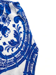 Crisscross halter neck maxi dress in blue and white ornate pattern.