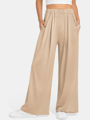 Pleated palazzo trousers in taupe with pockets and elastic waistband.