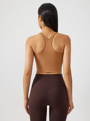 Sculpted racerback crop tank in caramel with a V-neck detail.