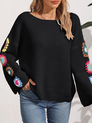 Black knit sweater with colorful granny square crochet sleeves and boat neck.