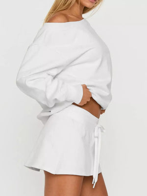 White cropped boat neck sweatshirt with mini skirt featuring drawstring detail