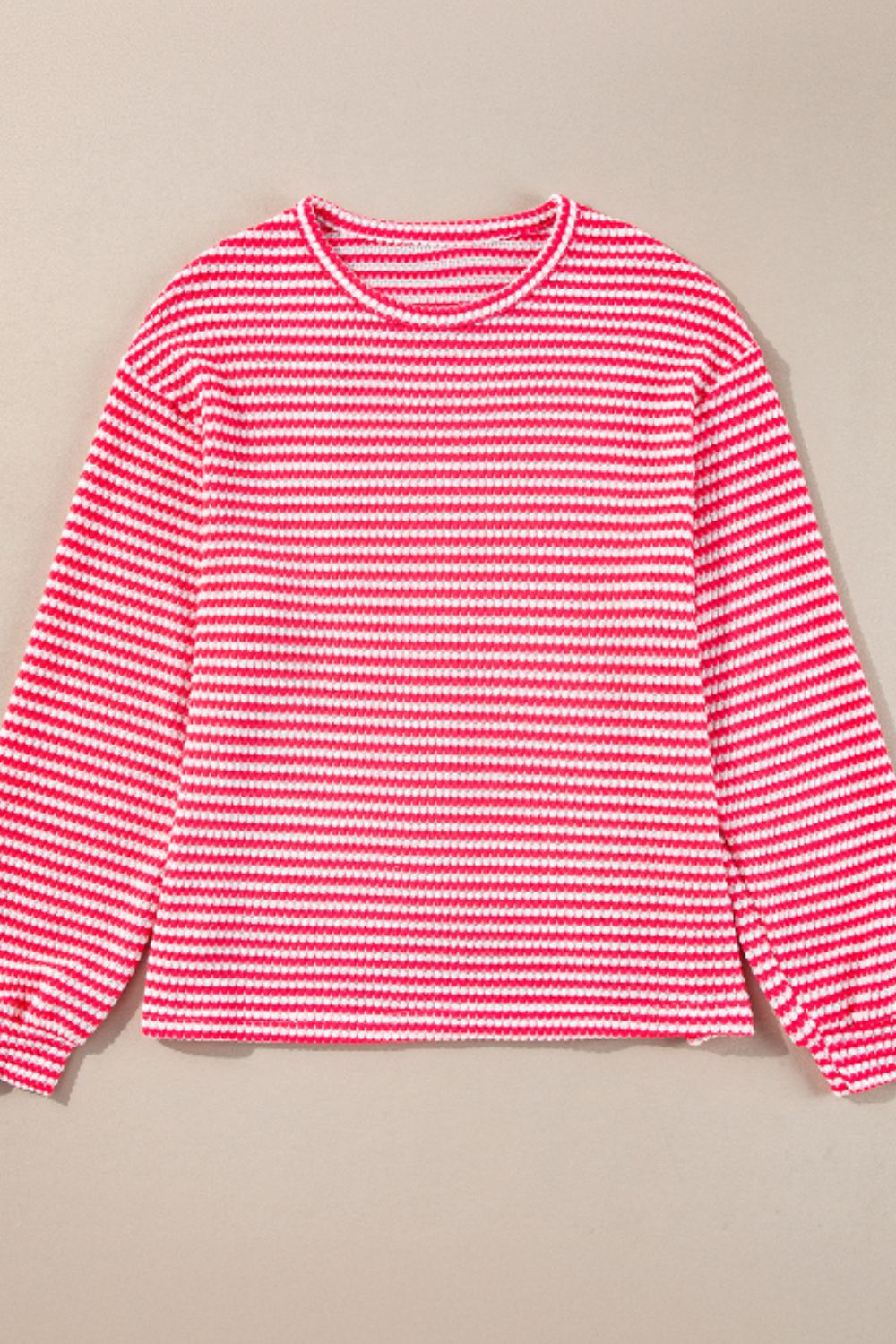 Textured stripe balloon sleeve top in pink and white with a crew neck.