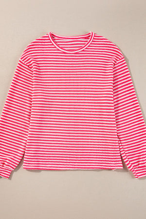Textured stripe balloon sleeve top in pink and white with a crew neck.