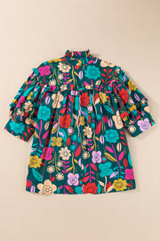 Botanical ruffle-sleeve tie-neck blouse in floral print with ruffled neckline and sleeves.