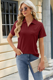 Burgundy textured polo shirt with V-neck and short sleeves.