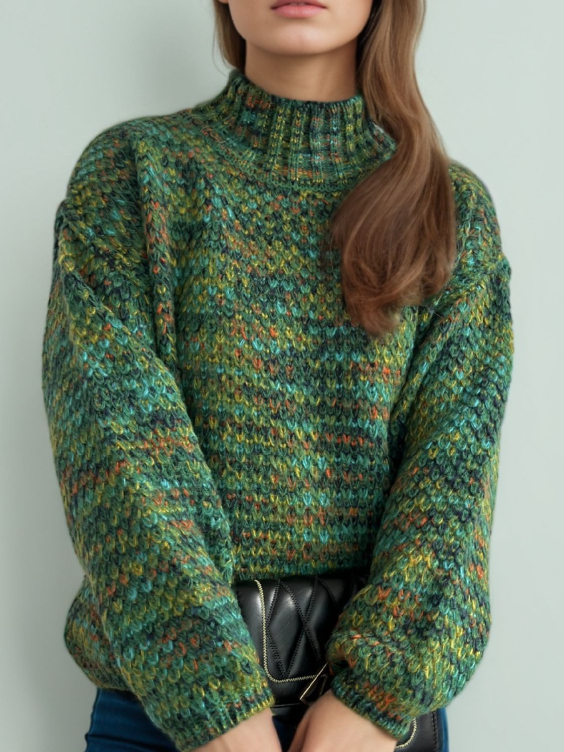 Textured mélange mock neck sweater in dark green with a chunky knit pattern.