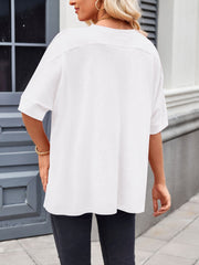 White relaxed fit t-shirt with short sleeves and a crew neck, styled casually.