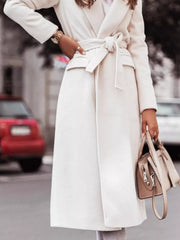 Belted longline trench coat in white with flap pockets and a tie waist.