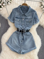 Chic buttoned denim romper with pockets and black belt.