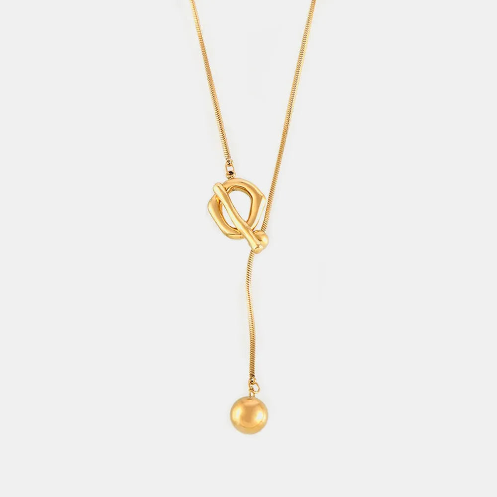 Gold lariat necklace with toggle closure and ball pendant