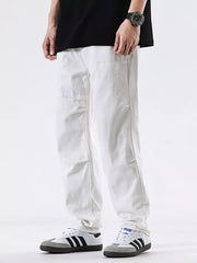 Men's white cotton jeans with a pocketed design and relaxed fit.