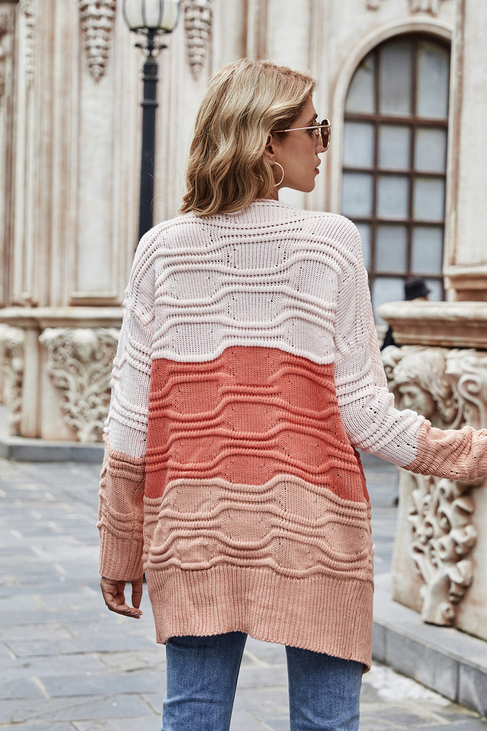 Ombre ribbed knit open cardigan in coral with colorblock pattern and textured waves.