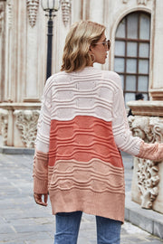 Ombre ribbed knit open cardigan in coral with colorblock pattern and textured waves.