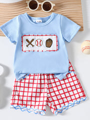 Baby blue cotton baseball top with embroidered baseball graphics and red plaid shorts.