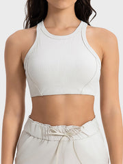 White ribbed racerback crop top with contour stitching and a high neckline.