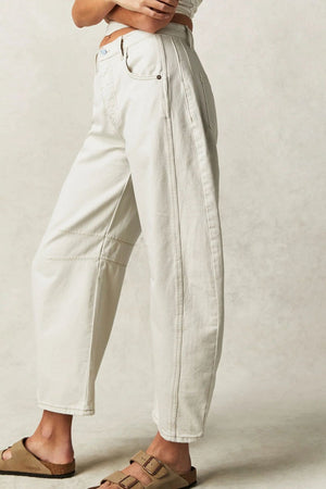 Cream denim barrel leg jeans with seam details and a buttoned fly.