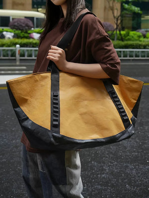 Two-tone yellow and black large capacity travel bag with black straps.