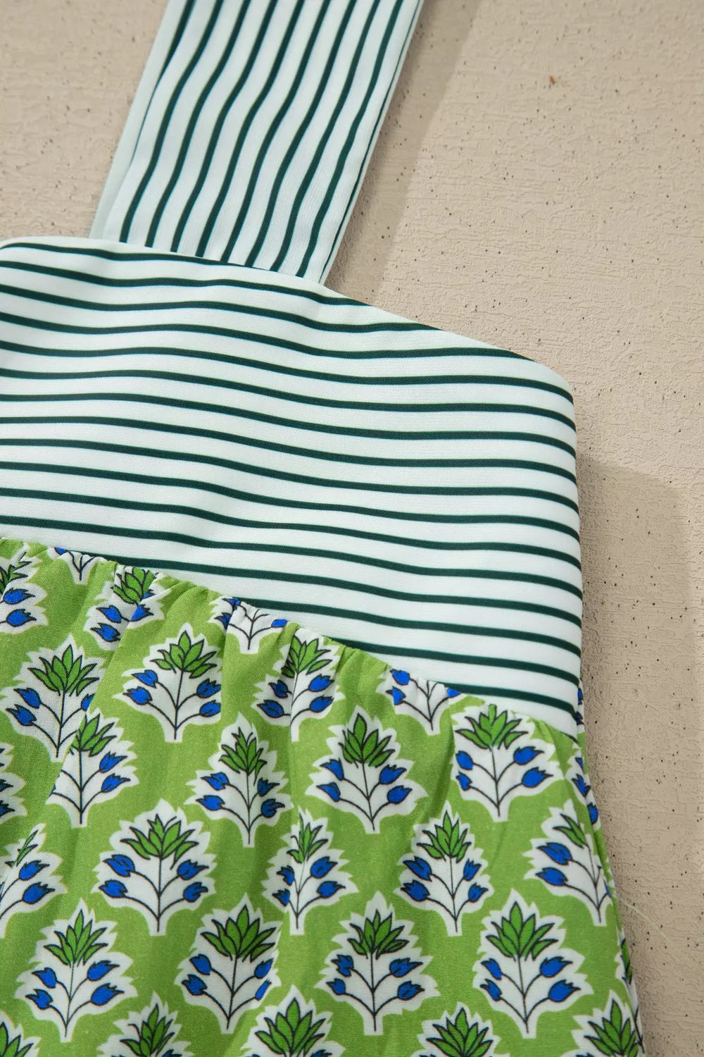 Floral tie-strap tank top with square neckline, green and white stripes and blue floral print.