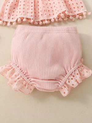 Pink cotton baby bloomers with eyelet ruffle trim and ribbed waistband.