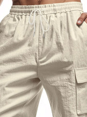 Khaki relaxed fit drawstring shorts with utility cargo pockets and elastic waistband.