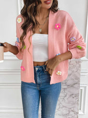 Pink acrylic knit cardigan with embroidered floral appliques, open front, long sleeves.